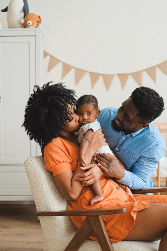 Young parents smiling with their newborn baby